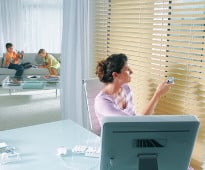 image showing woman observing custom blinds