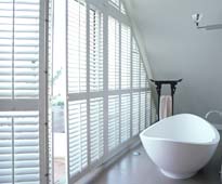image of bespoke white shutters in bathroom