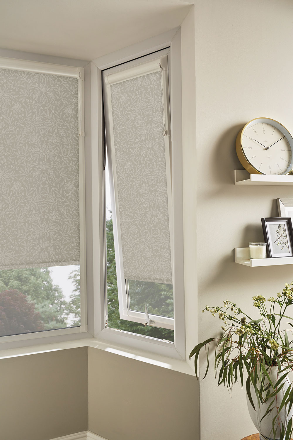 Perfect fit roller blinds shown partially closed on a outward opening window