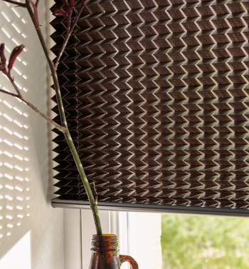 Patterned close up of a brown patterned pleated blind